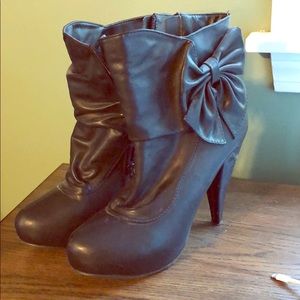 Black zip booties with bow detail